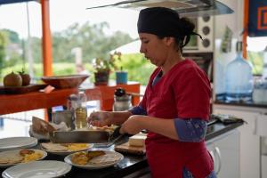 a woman preparing food in a kitchen at Finca La Coqueta Coffee Farm Stay near Filandia in Filandia