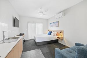 a hotel room with a bed and a sink at Avenue WEST Studio Units in Toowoomba