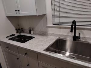 a kitchen with a sink and a counter top at Deco Studio Retreat with Fireplace, WiFi, Queen Bed in Reno +29 photos