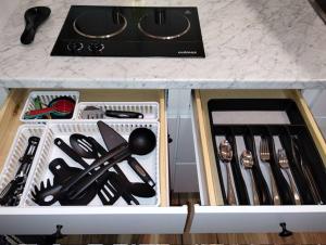 a drawer filled with utensils on top of a counter at Deco Studio Retreat with Fireplace, WiFi, Queen Bed in Reno