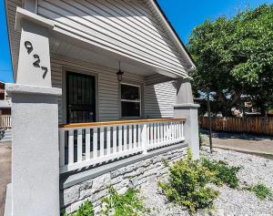 a house with a white fence and a porch at Deco Studio Retreat with Fireplace, WiFi, Queen Bed in Reno