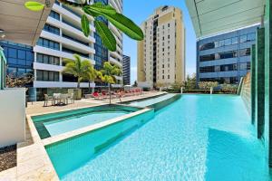 a swimming pool in the middle of a building at Aria Apartments in Gold Coast