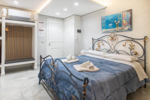 a bedroom with a blue bed with towels on it at Federico 70 Rubino in Palermo