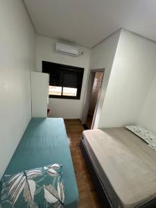 a room with two beds and a window at Borges Hotel, endereço Boa Vista das Missões in Jabuticaba