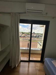 a room with a large glass door with a window at Borges Hotel, endereço Boa Vista das Missões in Jabuticaba