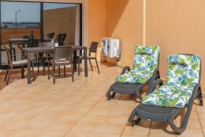 a room with a table and chairs and a dining room at Terrace View - Estrela Apartment in Luz