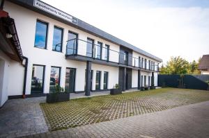 a large white building with a lot of windows at Apartamenty Mariańska 103 in Racibórz