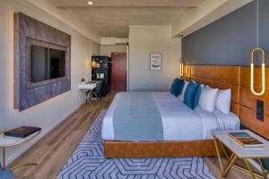 a hotel room with a large bed and a desk at SOHO Hotel Auckland in Auckland +20 photos