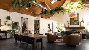 a living room with a wooden table and chairs at Violet Inn, Lounge & Spa in Two Rivers