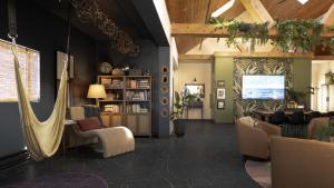 a living room with a hammock in a room at Violet Inn, Lounge & Spa in Two Rivers