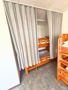 a bed room with a curtain in a bedroom at Magokoro House 203 in Nishiizu