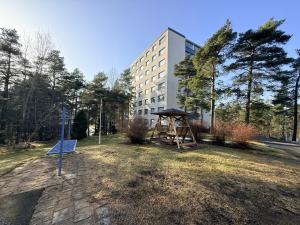 a park in front of a building with a playground at The Treetop Apartment in Turku