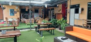 an outdoor patio with tables and chairs and a table at Dewi Sri Guesthouse in Mataram