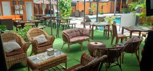 a group of chairs and tables in a patio at Dewi Sri Guesthouse in Mataram