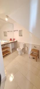 a bathroom with a toilet and a sink at Daniel in Lagoa +25 photos