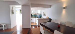 a kitchen with a wooden table in a room at Daniel in Lagoa