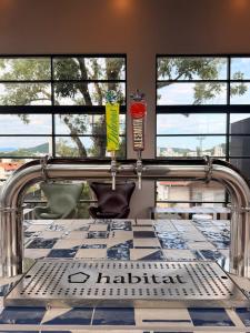 a dining room with a table and windows at ON Smart Lofts - 3 min a pé da Oktoberfest com cama Queen in Blumenau