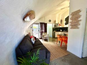 a person laying on a couch in a living room at Dome by the sea in Trinity Beach