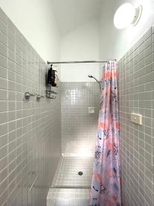 a bathroom with a shower with a shower curtain at Dome by the sea in Trinity Beach +25 photos