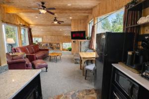 a kitchen with a living room with a refrigerator at Riverside Loft Suite home in Leavenworth +39 photos
