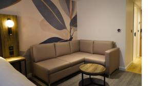 a living room with a couch and a table at Holiday Inn London Camden Lock by IHG in London +60 photos
