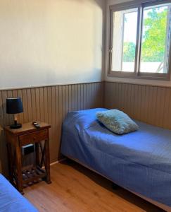 a bedroom with two beds and a table with a lamp at Hotel barrica in Realicó