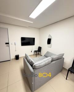 a living room with a couch and a flat screen tv at Studio Connect Life in Teresina
