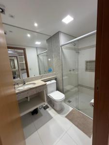 ein Badezimmer mit Toilette und Glasdusche in der Unterkunft Flat em Palmas no Vivence hotel in Palmas
