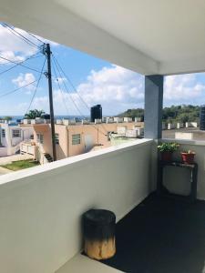 a balcony with a trash can and a view at Casa Bonita GLAM in Castries