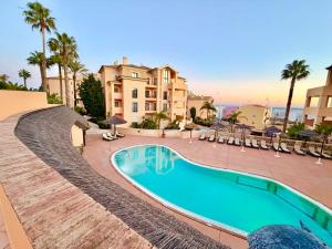 a swimming pool in front of a large building at Terrace View - Estrela Apartment in Luz +37 photos