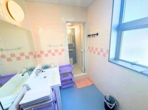 a bathroom with a sink and a mirror at Magokoro House 203 in Nishiizu +35 photos