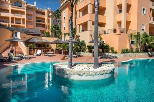 a swimming pool in front of a hotel at Terrace View - Estrela Apartment in Luz