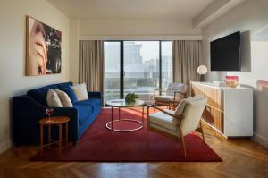 a living room with a blue couch and a table at SIXTY Beverly Hills in Los Angeles