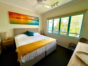 a bedroom with a bed and a large window at The Beachfront in Trinity Beach +52 photos