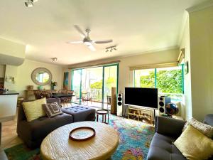 a living room with a couch and a table at The Beachfront in Trinity Beach