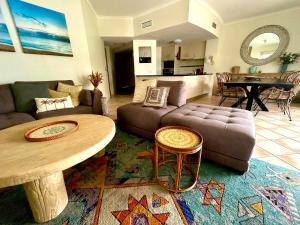 a living room with a couch and a table at The Beachfront in Trinity Beach