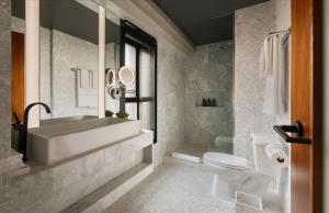 a bathroom with a tub and a toilet and a sink at SIXTY Beverly Hills in Los Angeles +59 photos