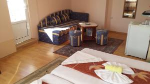 a living room with a couch and a table at Guest House Margarita in Pomorie