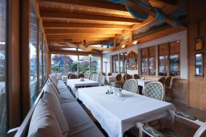 a dining room with white tables and chairs at Arthotel ANA Panorama, Trademark Collection by Wyndham in Marktoberdorf