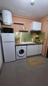 a kitchen with a sink and a washing machine at Le Maloha in Le Gosier +7 photos