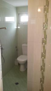 a bathroom with a toilet and a glass shower door at Guest House Margarita in Pomorie +29 photos