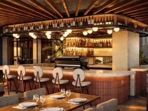 a restaurant with tables and a piano in the background at Devú in Medellín