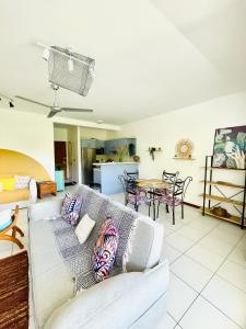 a living room with a couch and a table at Le Reka du Grand Large in Papeete