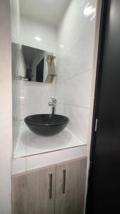a bathroom with a black sink and a mirror at HOTEL VITRU in Cúcuta