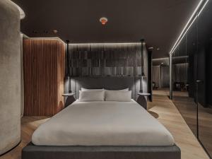 a bedroom with a large white bed in a room at Devú in Medellín