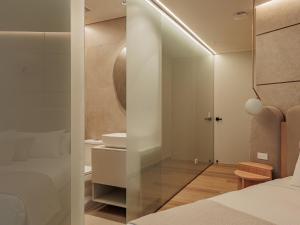 a bedroom with a shower and a bathroom with a sink at Devú in Medellín +26 photos