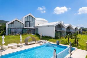 a house with a swimming pool in front of it at Gyeongju heybreeze Pool Villa in Gyeongju