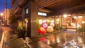 a building with colorful umbrellas on the side of it at Yamaga Onsen Sumi in Yamaga