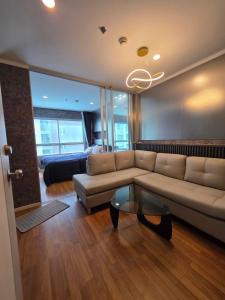 a living room with a couch and a glass table at Modern Grey in Udon Thani
