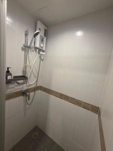 a shower in a tiled bathroom with a shower at Modern Grey in Udon Thani